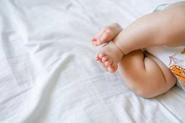 istock Cute little baby lying on bed, space for text. Banner design 2245441292