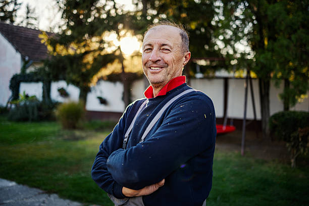 istock Senior worker portrait smiling outdoors at sunset 2245442302