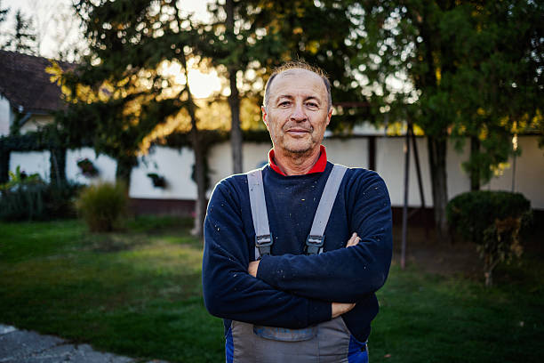 istock Mature man working in overalls standing outdoors 2245442310