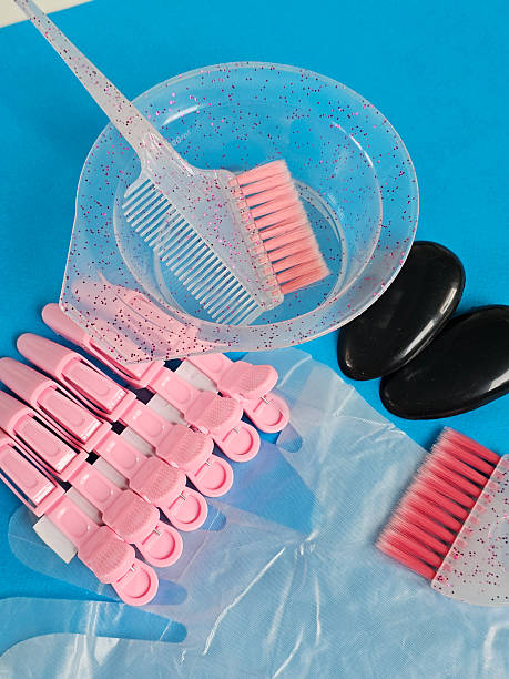 istock Tools and accessories arranged for a hair coloring activity on a colorful background concept 2245445571