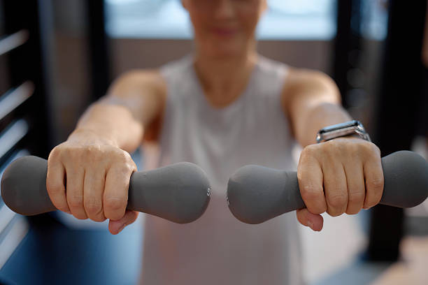 istock Woman Exercising with Dumbbells Indoors during Workout 2245446275