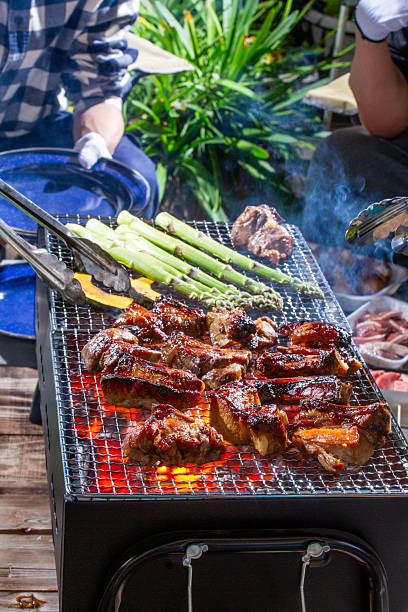 A Japanese man enjoying a spare rib barbecue on his balcony