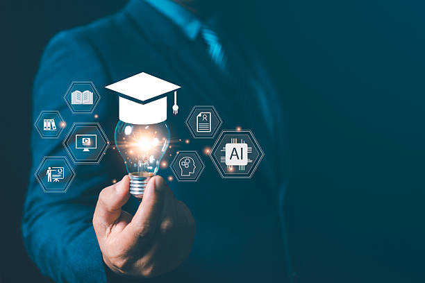 istock Businessman holding glowing light bulb with graduation cap and AI icon representing smart learning, digital education, artificial intelligence, knowledge innovation, and future technology concept. 2245449168