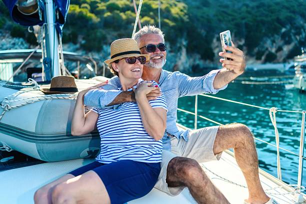 istock Senior couple taking a selfie on a sailboat 2245451412
