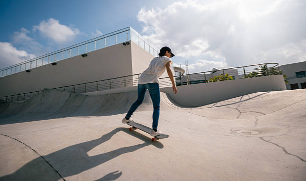 istock Skateboarder skateboarding at skatepark in city 2245453705