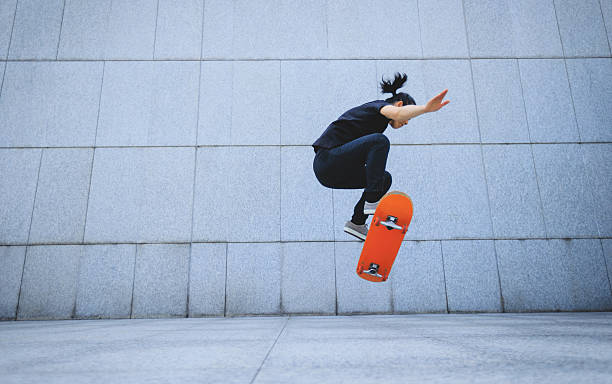 istock Skateboarder skateboarding at skatepark in city 2245457587