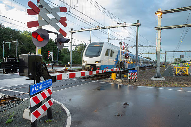 istock Railway crossing in the Netherlands, train and red lights. 2245458133