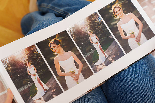 istock Female hands flipping through a photo book with wedding photos 2245462425