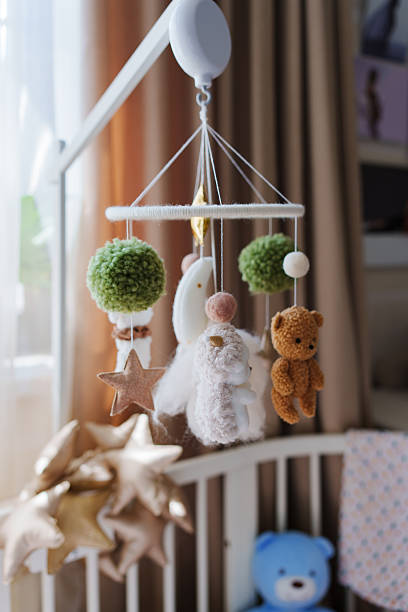 istock Cute baby mobile with stuffed animals and stars 2245464155