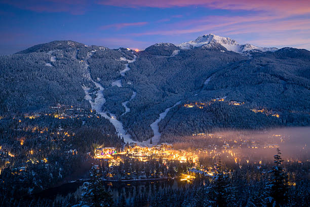 Fresh snow on Creekside Village, ski slopes and forest at sunset, Creekside Village, Whistler, B.C.