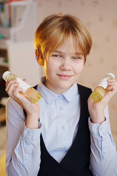 istock Young girl holding aroma diffuser liquid in a cozy indoor setting 2245465039