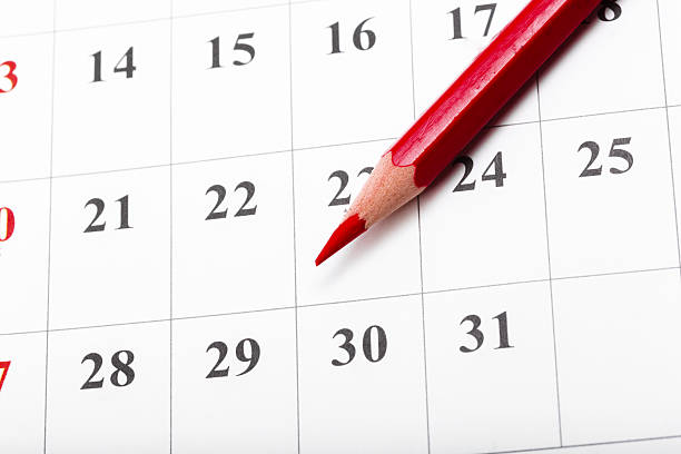 istock Red pencil marking a date on a calendar during the month 2245467887