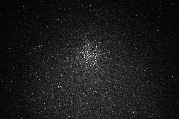 istock Dark granular background with asphalt relief scattered sparkles and focused central glowing area 2245468010