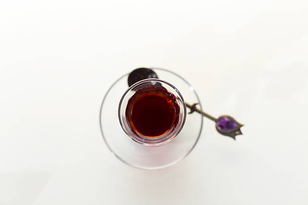 istock Rich dark beverage in a glass with an intricate spoon resting beside it 2245468200