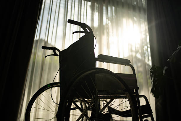 istock Wheelchair by the window. 2245468571