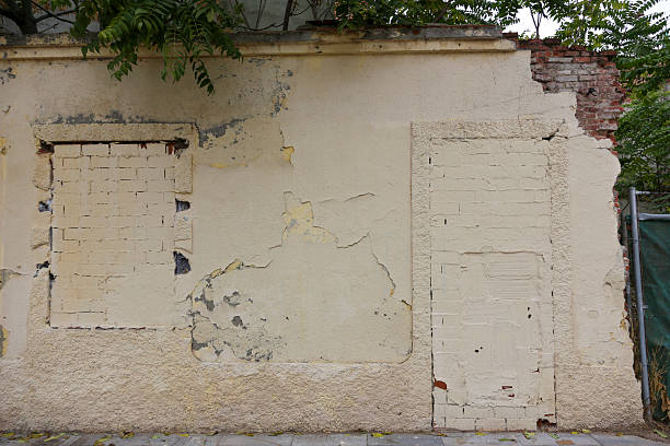 istock Texture of a brick wall with old, peeling paint in some partially ruined buildings 2245468721