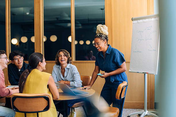 istock Group discussing and brainstorming ideas with a leader presenting a concept 2245471488