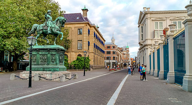 Hague, Netherlands - August 20, 2018 - Historic european street with equestrian statue and classical architecture.