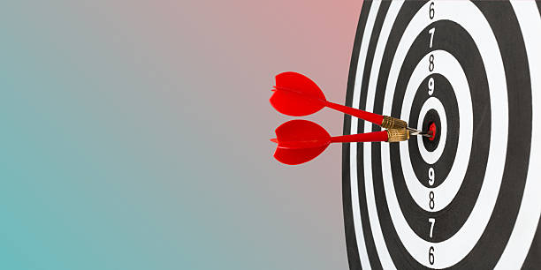 istock Darts hitting the bullseye on a target during a game night in a cozy room 2245472945