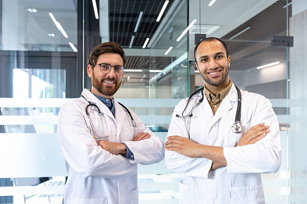 istock Two friendly doctors with stethoscopes stand together, ready to help patients with expert care. 2245472971