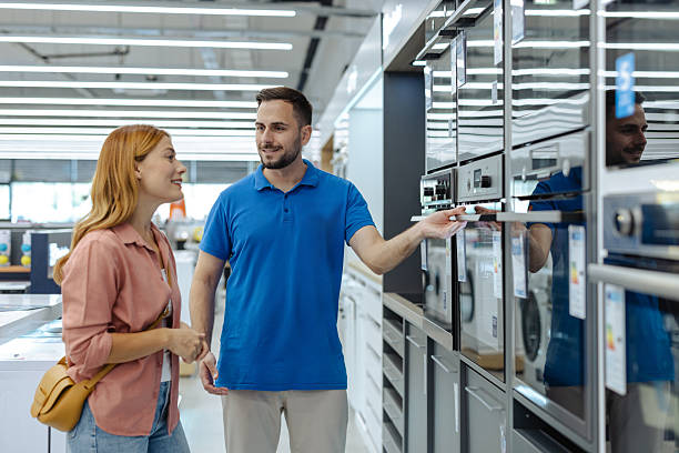 istock Salesman helps customer choose a modern appliance in electronics store during shopping visit 2245473802
