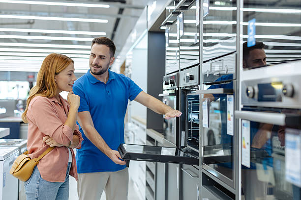 istock Salesman helps customer choose a modern appliance in electronics store during shopping visit 2245473819