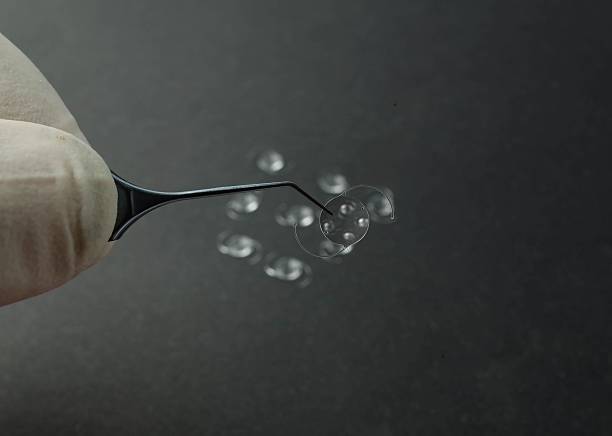 istock Gloved hand holding a contact lens. 2245473941