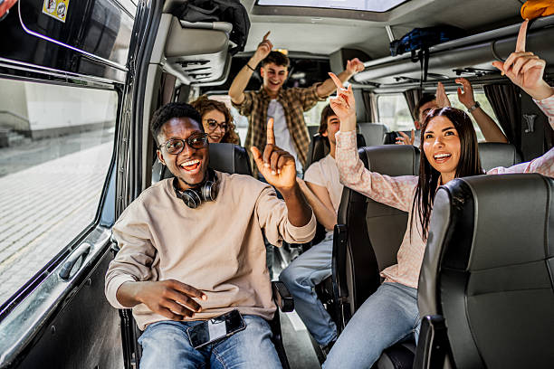 istock Happy young students having fun traveling on a bus 2245474294