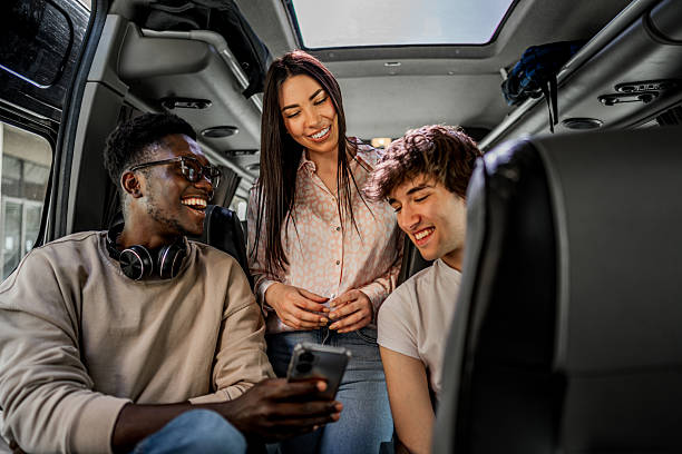 istock Students traveling by bus, laughing and using smartphone 2245475224