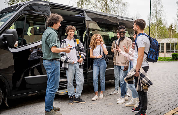 istock Teacher talking with students traveling by school van 2245475359
