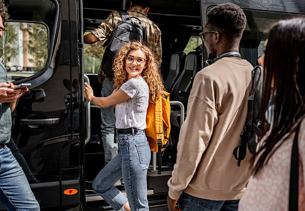 istock Young adults boarding bus for fun group trip 2245475483