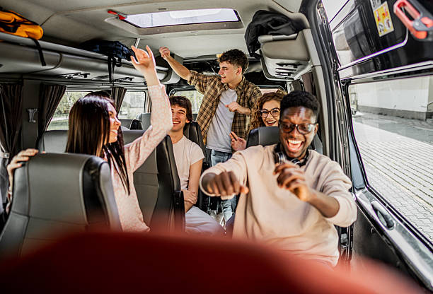 istock Young diverse friends enjoying fun road trip in van 2245475609