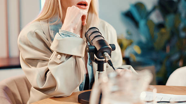 istock Podcast, talking or woman in studio with microphone, discussion or personal story in streaming show. Broadcast, digital or influencer in booth with tech, announcement or sharing idea in chat. 2245475644