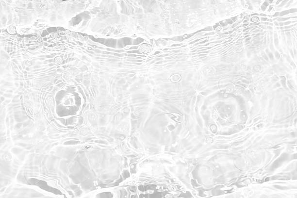 istock White water with ripples on the surface. Defocus blurred transparent white colored clear calm water surface texture with splashes and bubbles. Water waves with shining pattern texture background. 2245476178