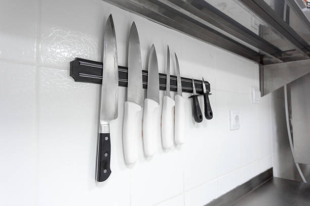 istock Collection of kitchen knives displayed on a magnetic strip in a modern kitchen 2245477817