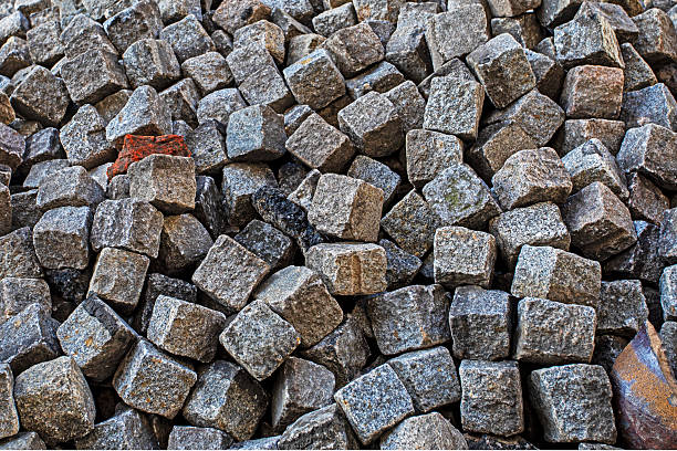 Stone burshtka piled up before a sidewalk resurfacing in the city.