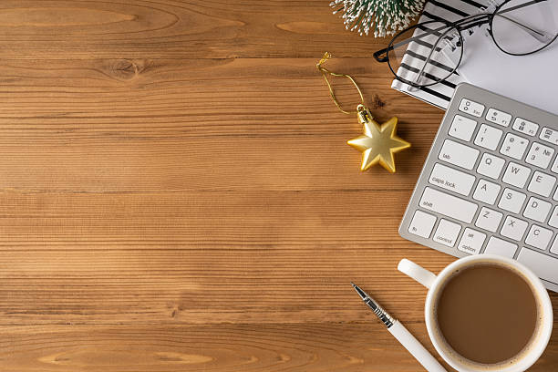 istock A cozy office scene featuring a white keyboard, coffee cup, pen, notebook, and a golden star ornament for Christmas and New Year celebrations 2245480512