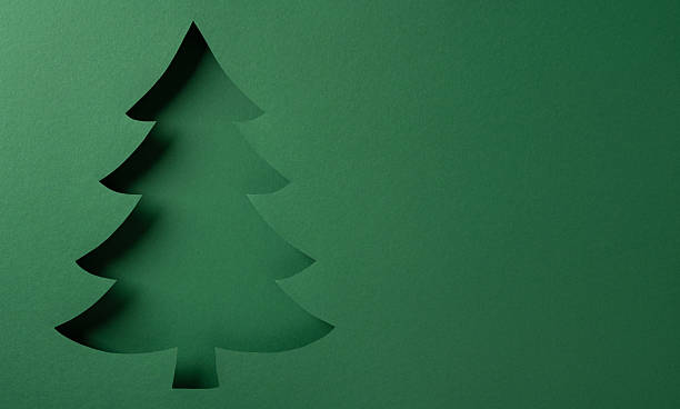 istock A minimal green Christmas tree cutout stands against a smooth green backdrop, evoking holiday spirit and festive greeting for Christmas and New Year celebrations, ideal for seasonal design 2245480548