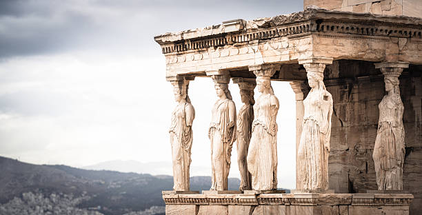 A view of several Greek Goddesses making up a collonade at The Erechtheum on The Acropolis in Athens, Greece.