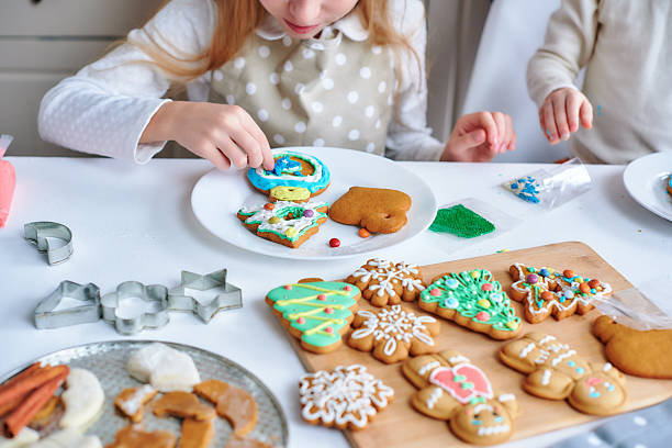 istock Children's hands decorate christmas gingerbread. 2245482547
