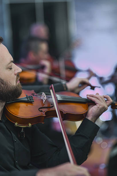 istock Violin Ensemble In Session: Musicians Playing Strings Together In A Live Performance 2245483252