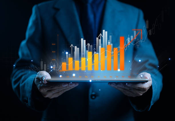 istock Businessman holding digital tablet with glowing bar graph and growth chart, representing business analytics, data visualization, financial success, and performance strategy. 2245483257
