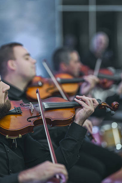 istock Violin Ensemble In Session: Musicians Playing Strings Together In A Live Performance 2245483483