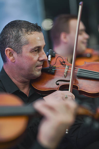 istock Violinist Plays With Focus In A Live Music Session During Ensemble Performance 2245483699