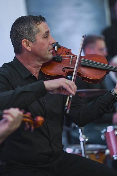 istock Violinist In Black Shirt Performing Live Session With Focused Expression 2245483734