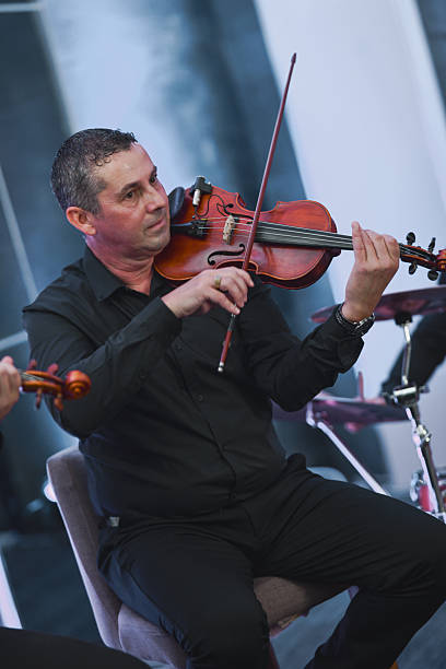 istock Violinist In Black Shirt Performing Live Session With Focused Expression 2245483859