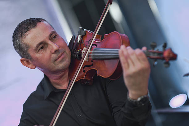 istock Violinist In Black Shirt Performing Live Session With Focused Expression 2245484063