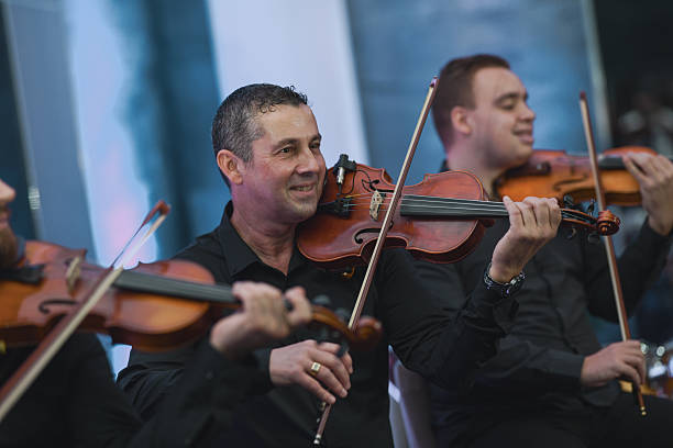istock Violinist Plays With Focus In A Live Music Session During Ensemble Performance 2245484195