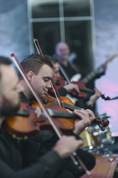 istock Violin Ensemble In Session: Musicians Playing Strings Together In A Live Performance 2245484245