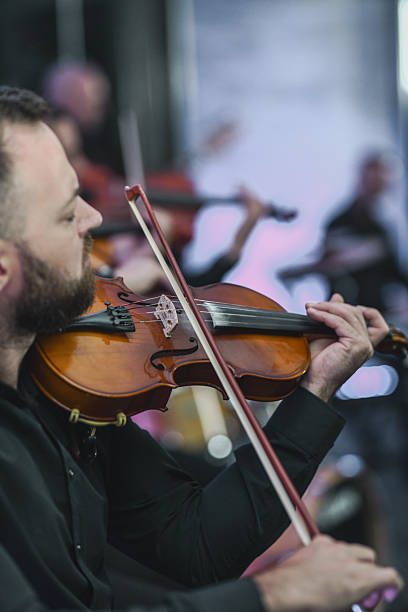 istock Violin Ensemble In Session: Musicians Playing Strings Together In A Live Performance 2245484346